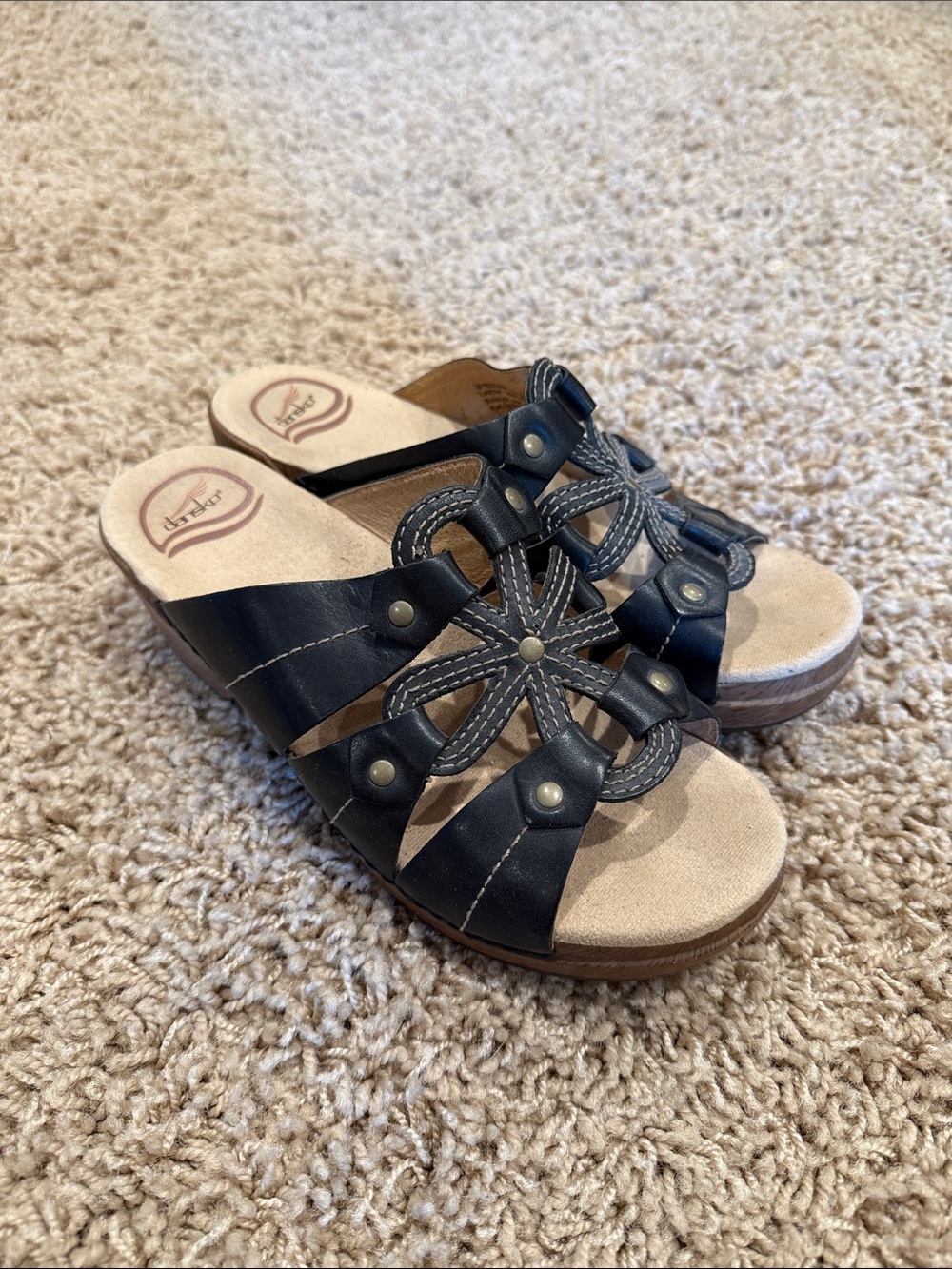 Dansko Black Leather Slip-On Mules with Braided Floral Accent